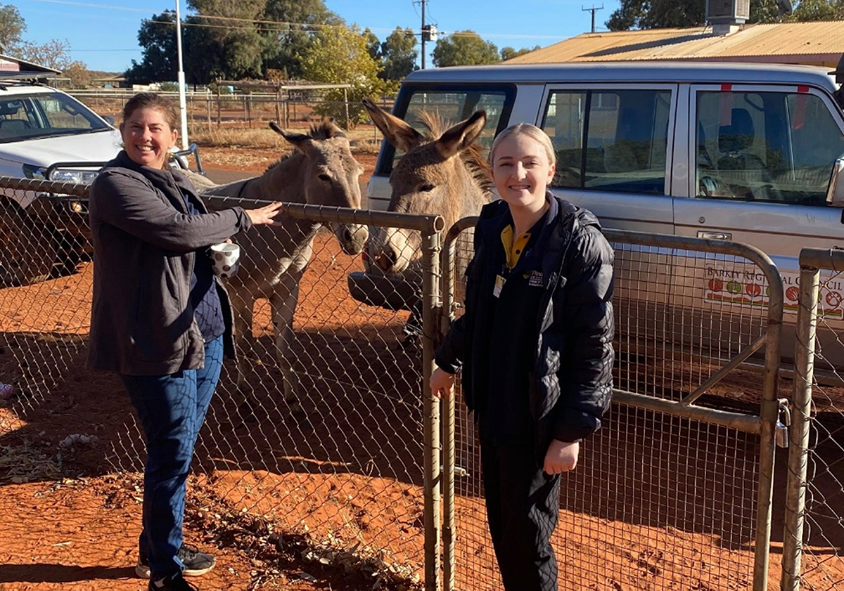 Jordyn Iovino and Kylie Adams Occupational Therapist Supervisor at the aged care clinic with wild donkeys in Ampilatwaja